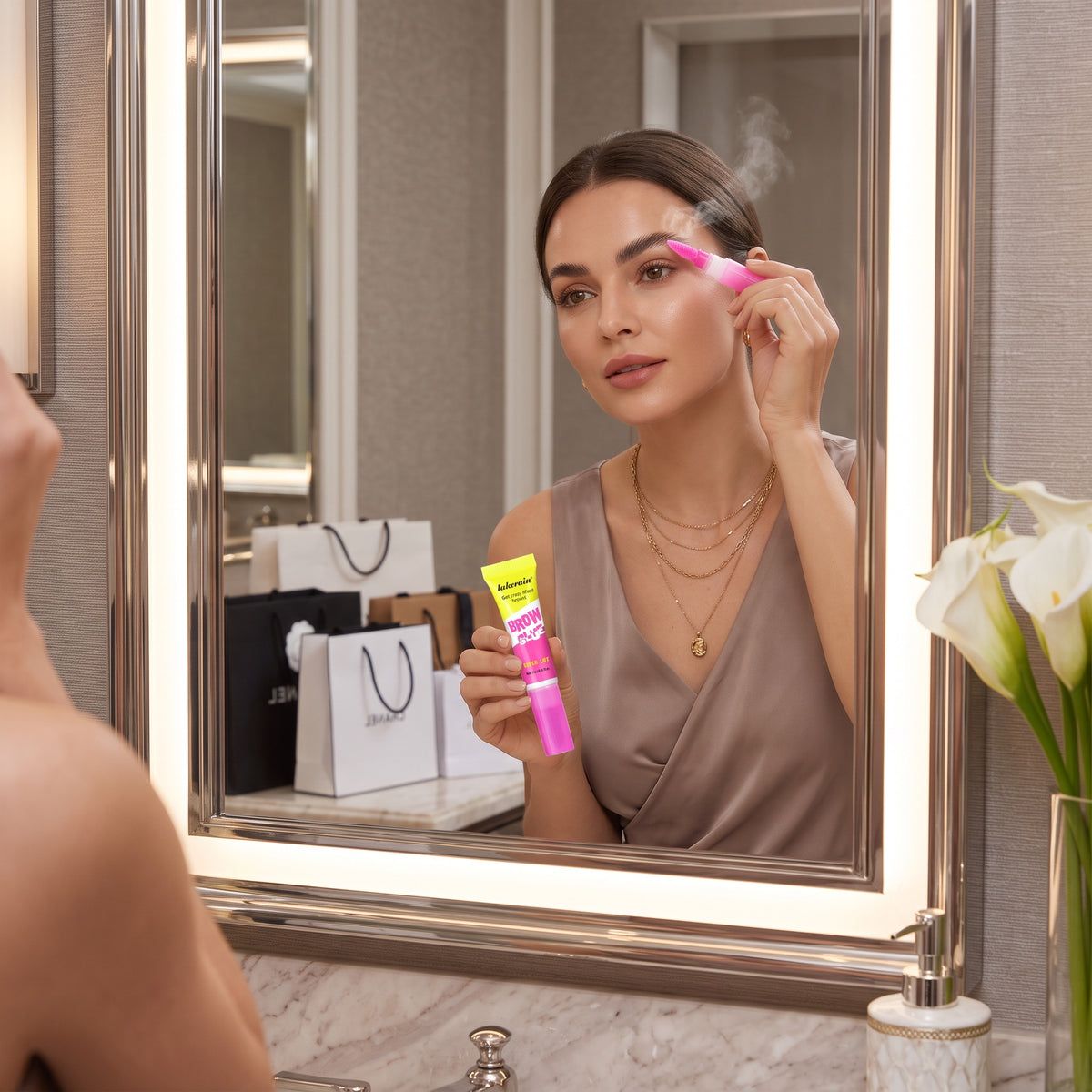 Lifestyle photo of BrowLatch Clear Brow Glue on a vanity